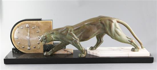 An Art Deco three colour marble and bronzed spelter mantel timepiece, width 30in.